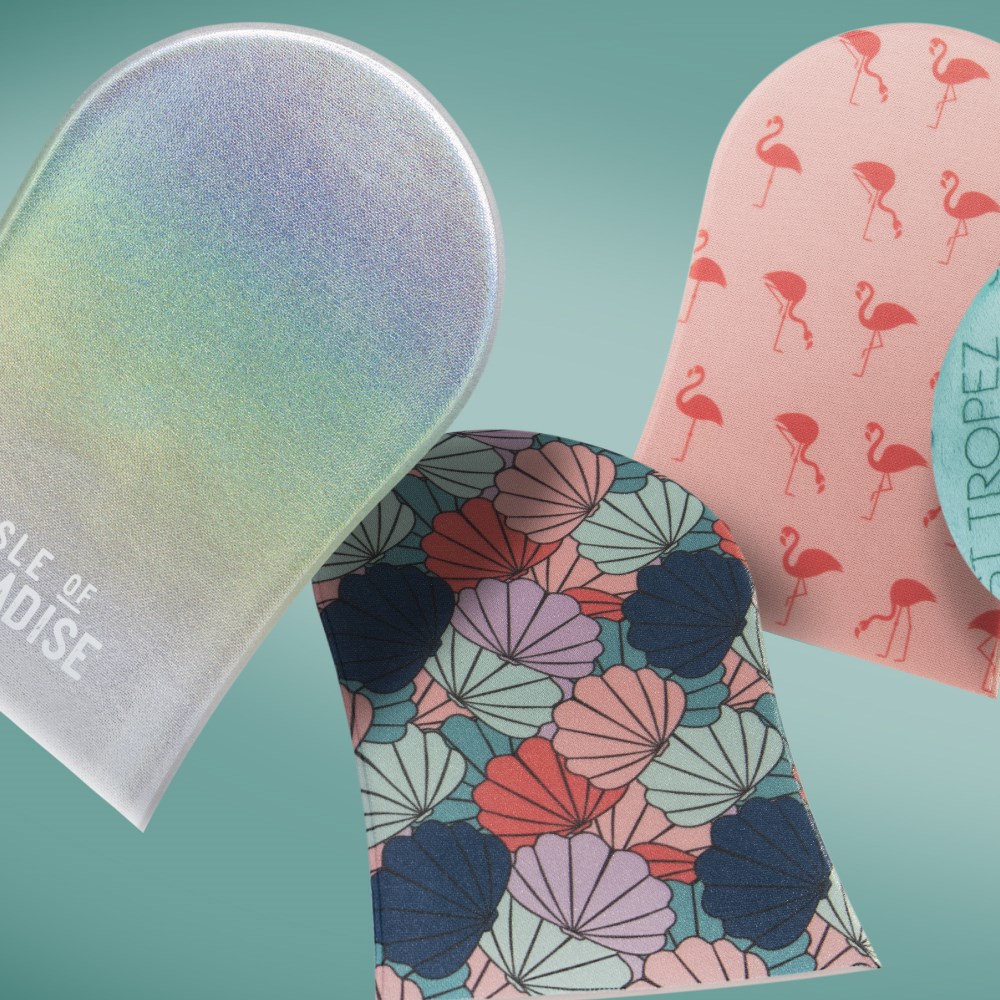 image: 3 tanning mitts on an aqua background, one with a rainbow design, one with a seashell design, and one with a flamingo design