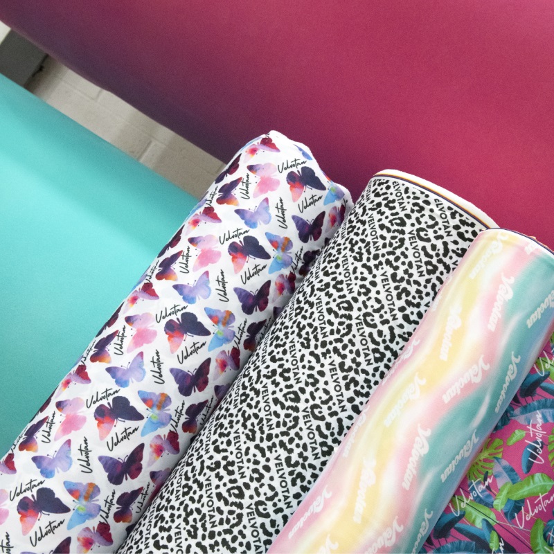 image: photo of several rolls of tanning mitt design produced in our factory: butterfly, leopard print, and rainbow